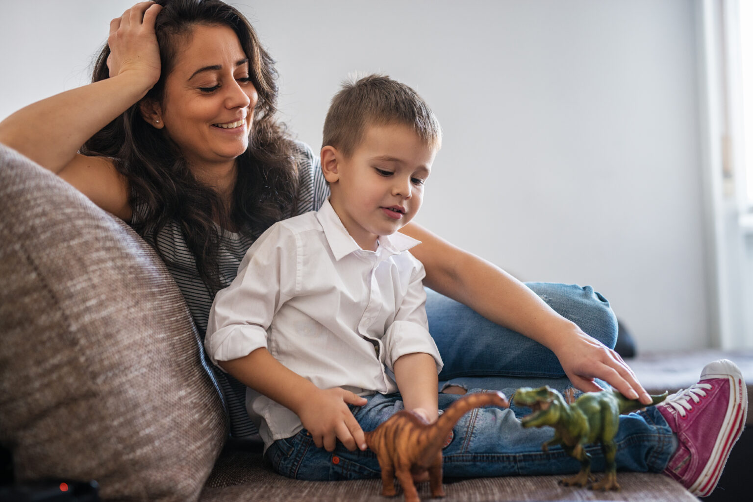 Mother and child sitting together on a sofa