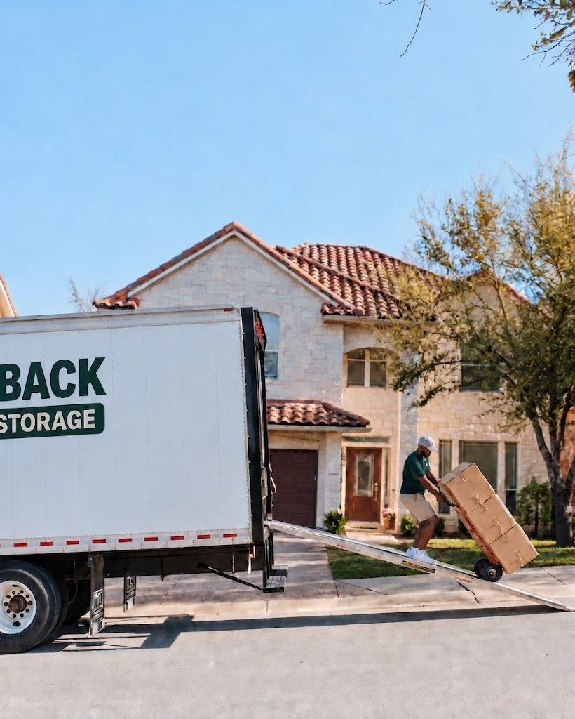 Razorback Moving crew member loading a boxed item beside a branded truck
