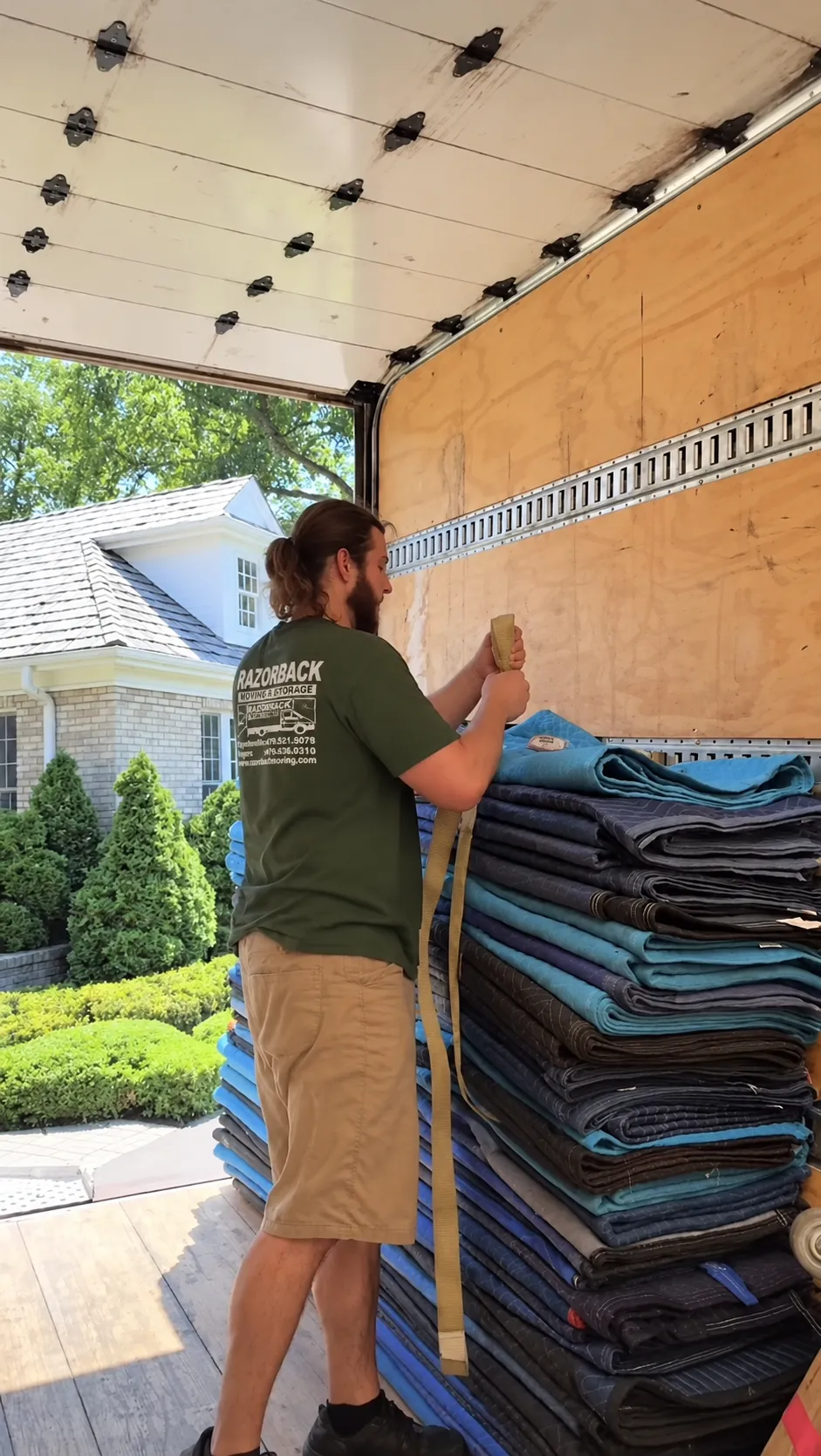 Razorback mover preparing moving blankets